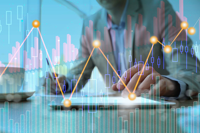 Image of Forex trading. Double exposure of charts and man using tablet computer, closeup
