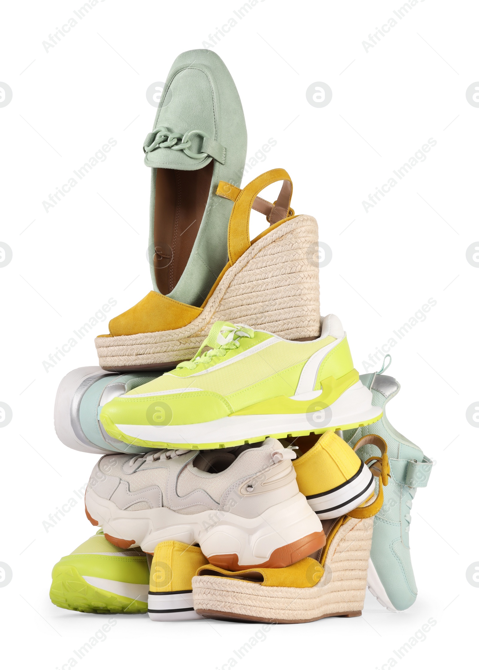 Photo of Pile of different female shoes isolated on white