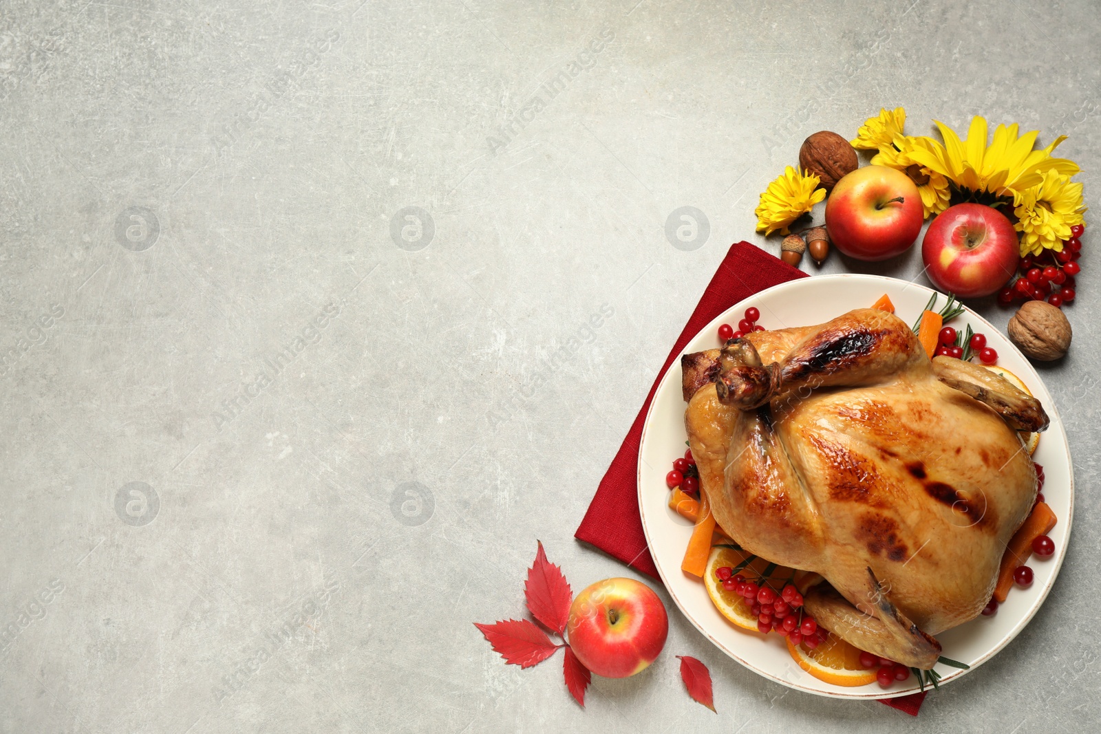 Photo of Traditional cooked turkey and autumn decor on light table, flat lay with space for text. Thanksgiving day celebration