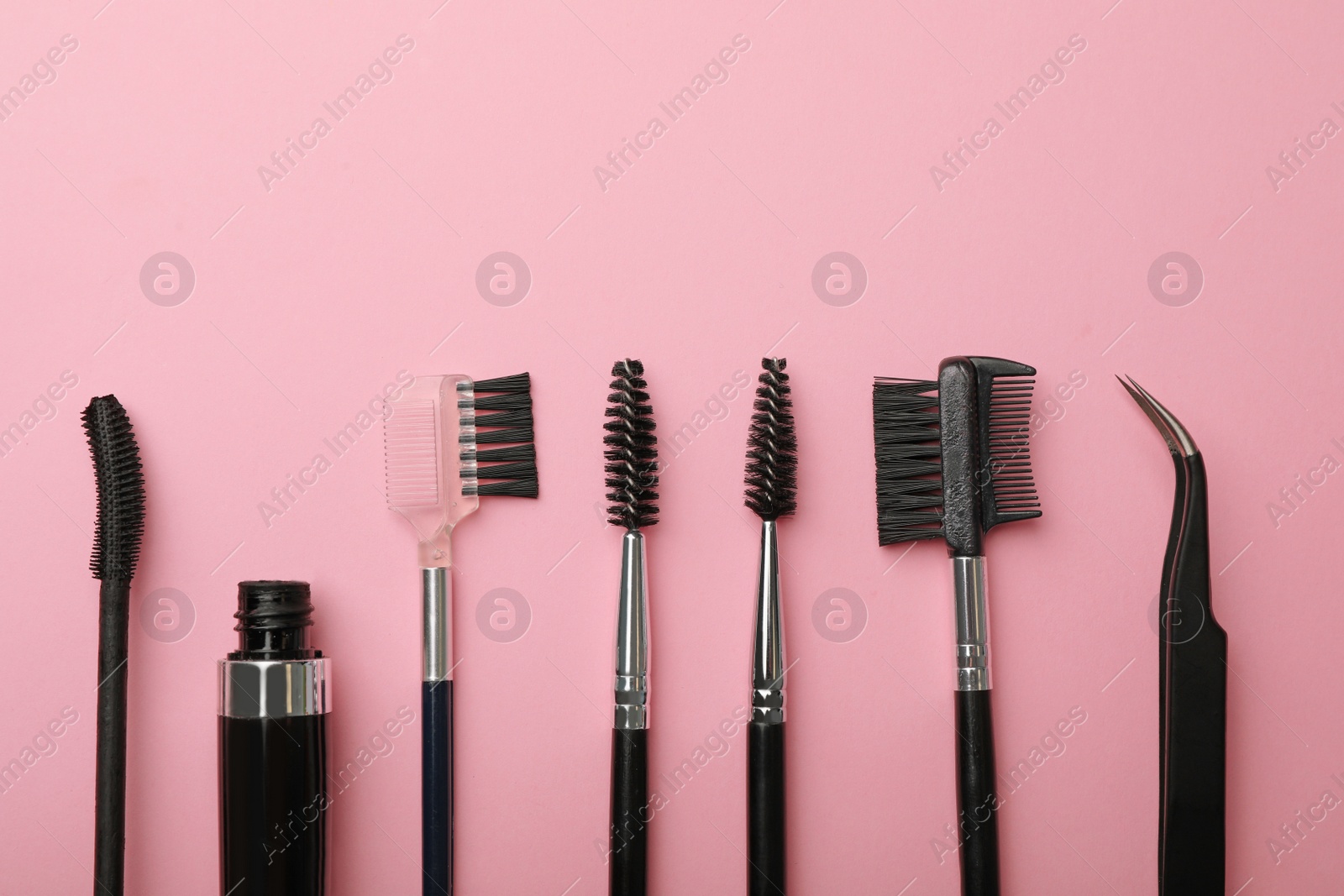 Photo of Flat lay composition of professional makeup tools for eyelashes on color background