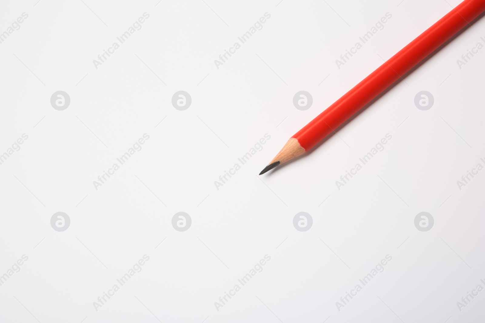 Photo of Sharp graphite pencil on white background, top view. Space for text