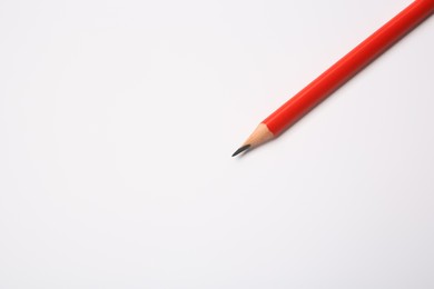 Photo of Sharp graphite pencil on white background, top view. Space for text
