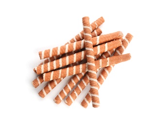 Delicious chocolate wafer rolls on white background, top view. Sweet food