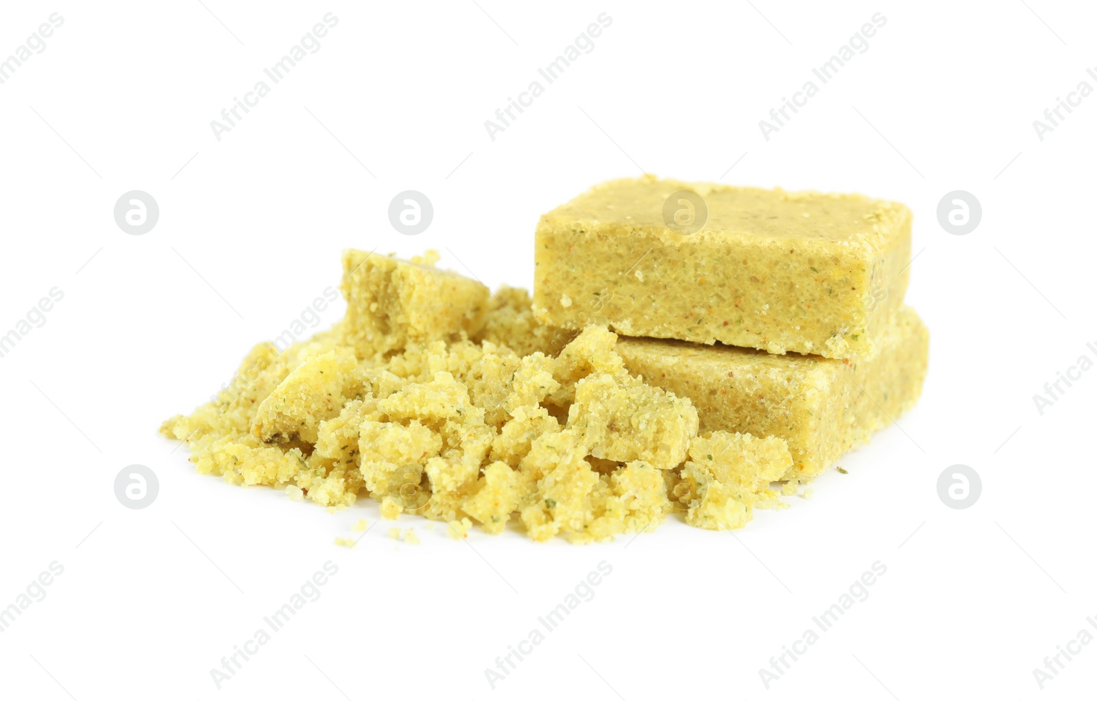 Photo of Aromatic crumbled and whole bouillon cubes on white background