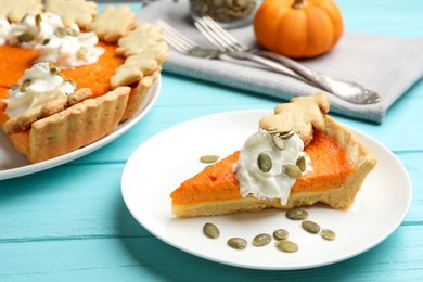 Photo of Delicious homemade pumpkin pie on light blue wooden table