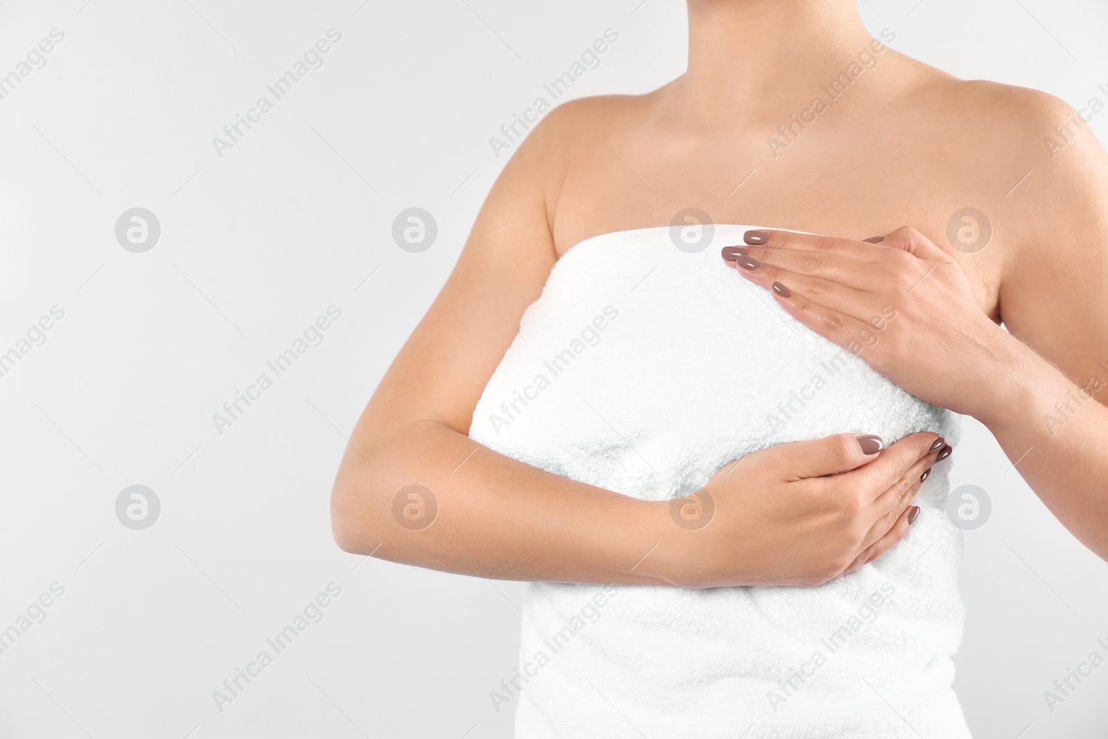 Photo of Woman checking her breast on white background, closeup