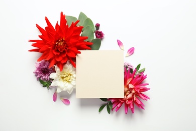 Photo of Flat lay composition with beautiful dahlia flowers and blank card on white background