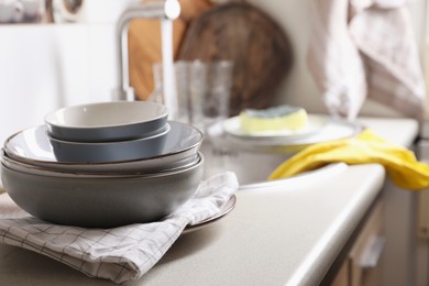 Photo of Clean bowls near kitchen sink. Washing dishes