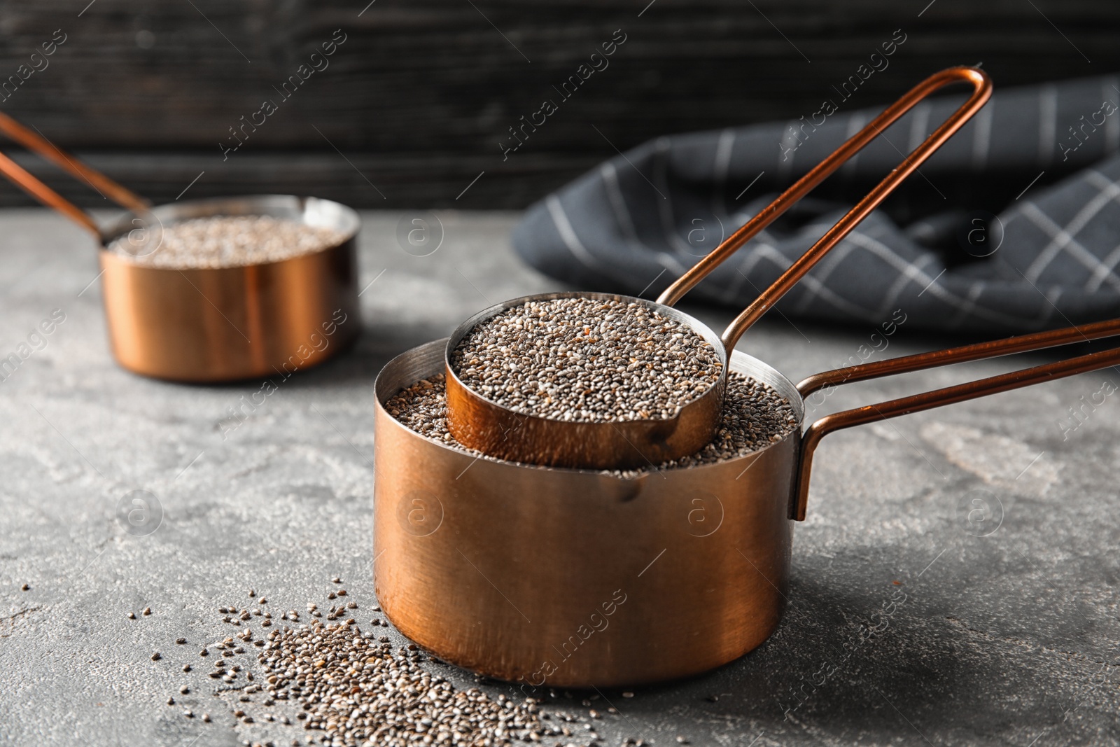 Photo of Saucepans with chia seeds on grey table