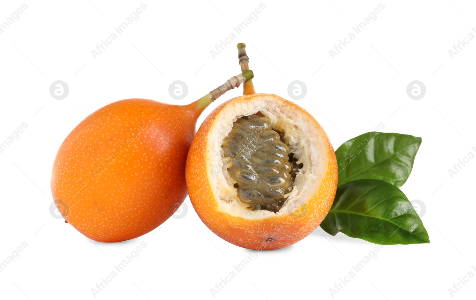 Photo of Whole and cut delicious granadillas with leaves on white background