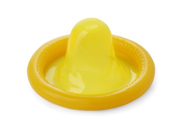 Photo of Unpacked yellow condom isolated on white. Safe sex