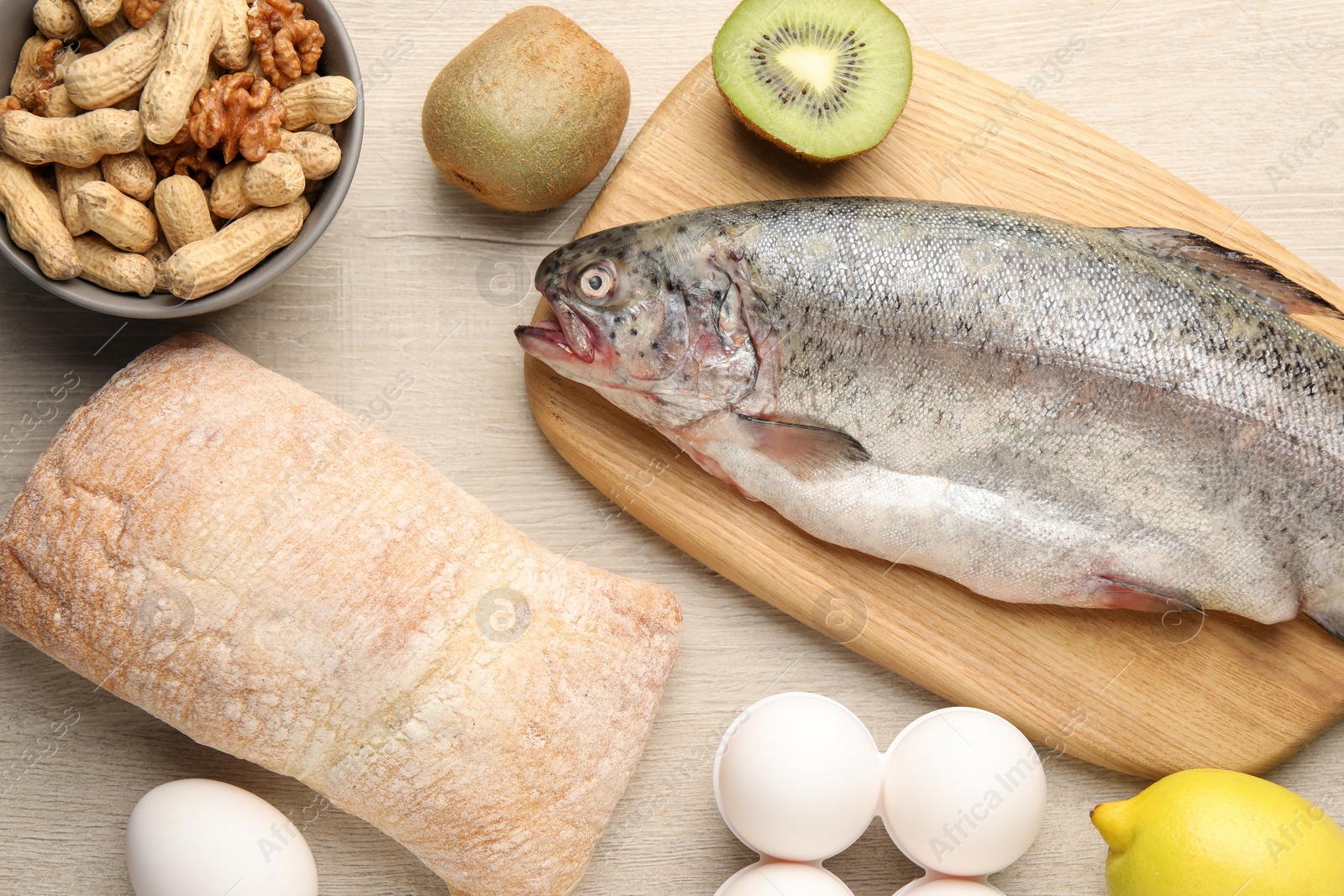 Photo of Allergenic food. Different fresh products on wooden table, flat lay