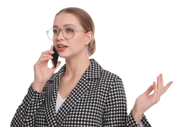 Young businesswoman talking on mobile phone against white background