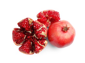 Photo of Whole and cut fresh pomegranates isolated on white, top view