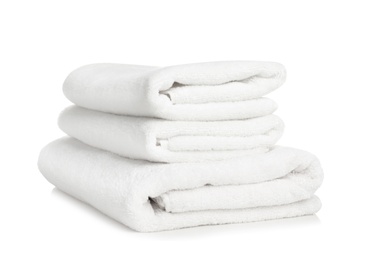 Photo of Folded soft terry towels on white background