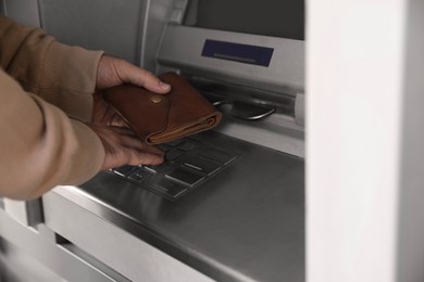 Man entering cash machine pin code, closeup