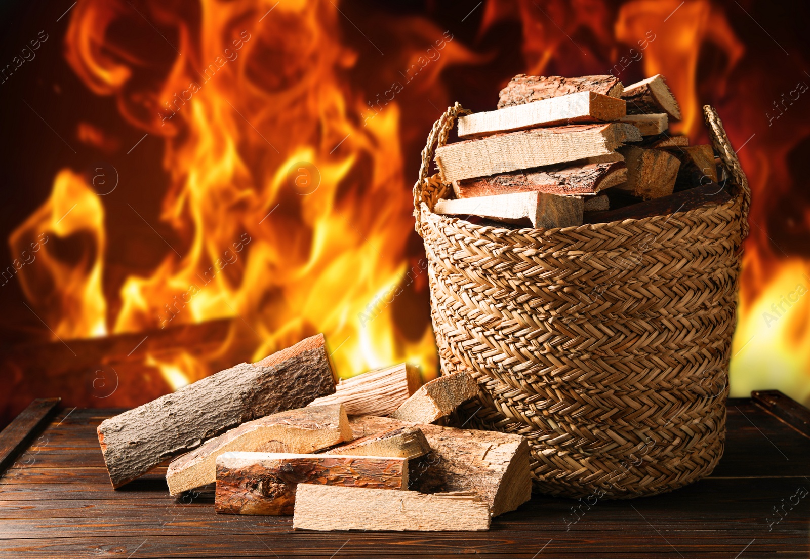 Image of Dry wood and burning fire on background. Cozy atmosphere