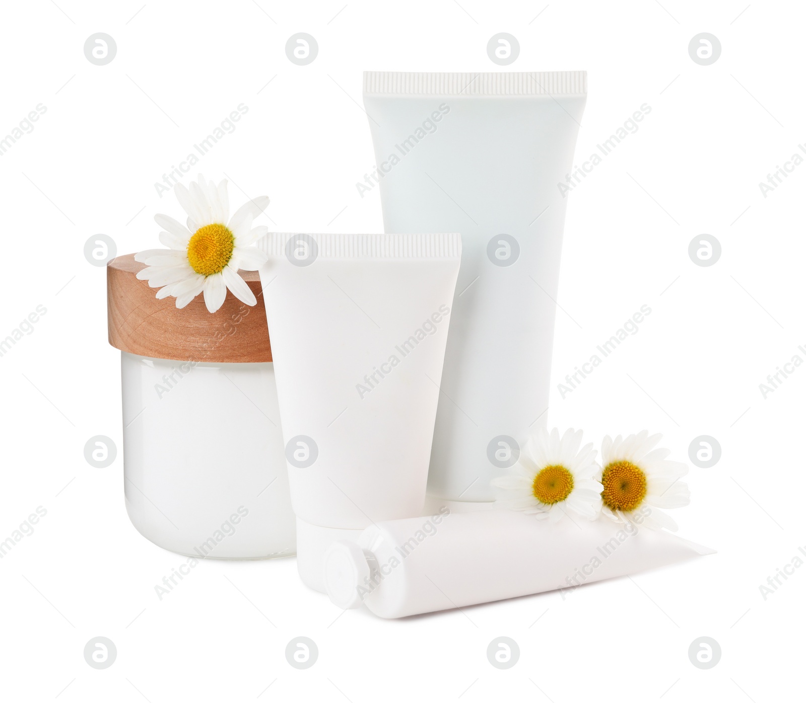 Photo of Different hand care cosmetic products and chamomiles on white background