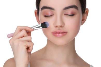 Photo of Teenage girl with makeup brush on white background