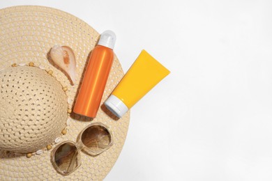 Flat lay composition with sunscreens on white background, space for text. Sun protection care