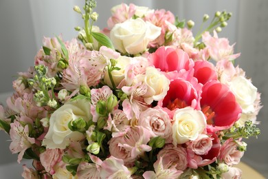 Photo of Beautiful bouquet of fresh flowers in room, closeup
