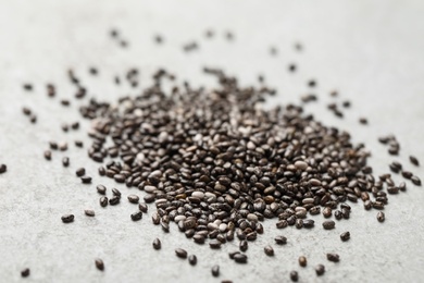 Pile of chia seeds on light grey table, closeup