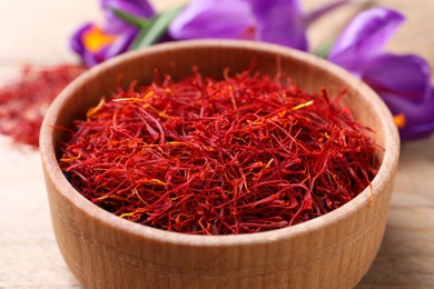 Photo of Dried saffron and crocus flowers on table, closeup