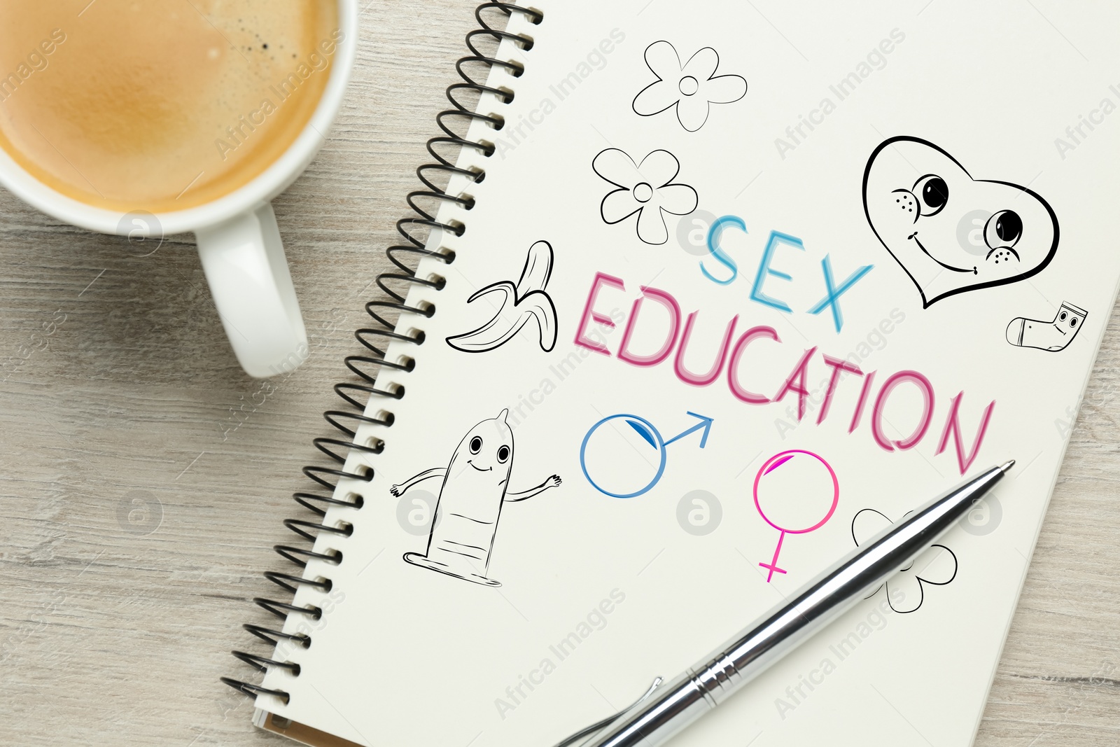 Image of Notebook with text Sex Education, male and female gender signs and different drawings on white wooden table, top view