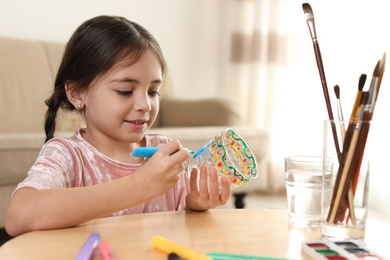 Little girl painting glass at table indoors. Creative hobby