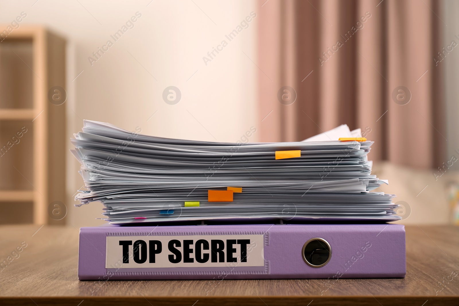 Image of Top Secret stamp. Stacked documents and folder on wooden table indoors