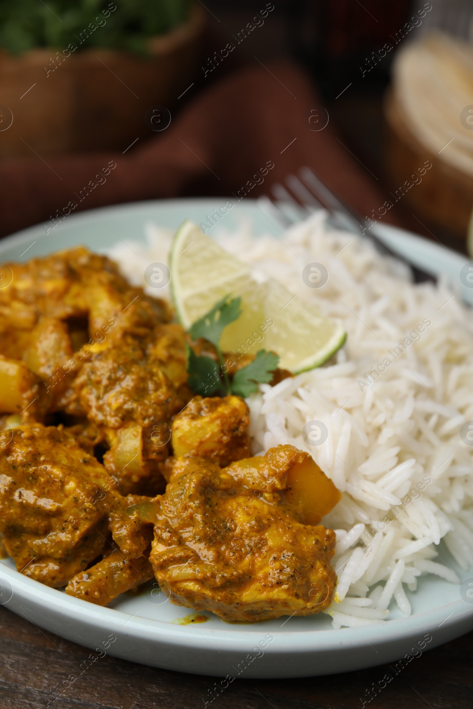 Photo of Delicious chicken curry with rice on table, closeup