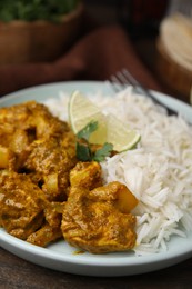 Photo of Delicious chicken curry with rice on table, closeup