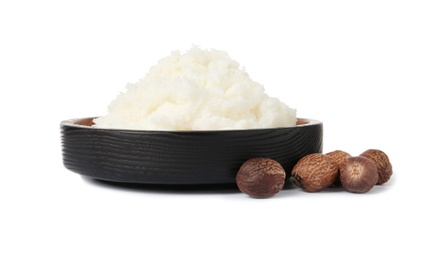 Photo of Shea butter in bowl and nuts isolated on white