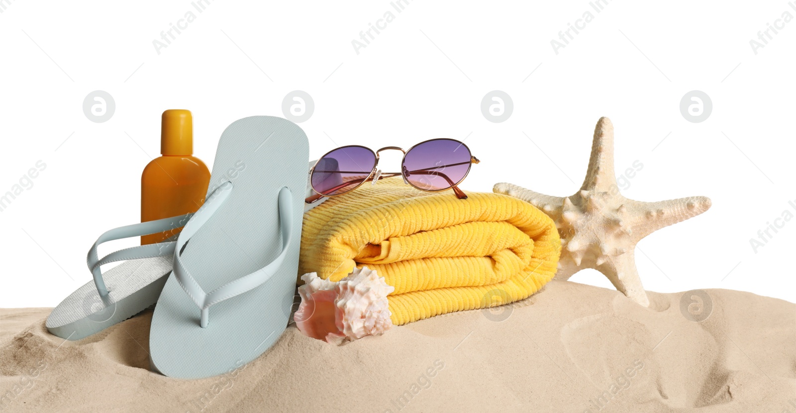 Photo of Different beach objects on sand against white background