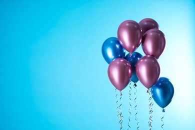 Photo of Bright balloons on color background. Space for text
