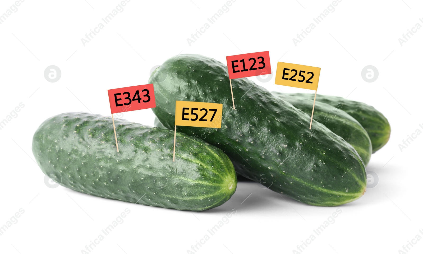 Image of Fresh cucumbers with E numbers on white background. Harmful food additives 