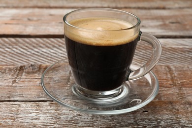 Photo of Cup of aromatic coffee on wooden table, closeup