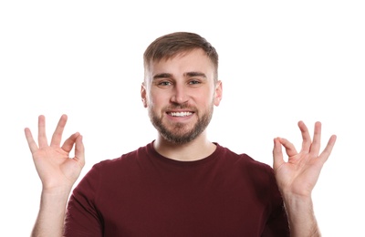 Photo of Man showing OK gesture in sign language on white background