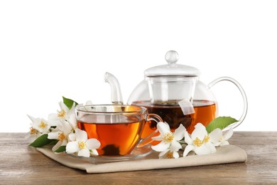 Photo of Aromatic jasmine tea and fresh flowers on wooden table against white background