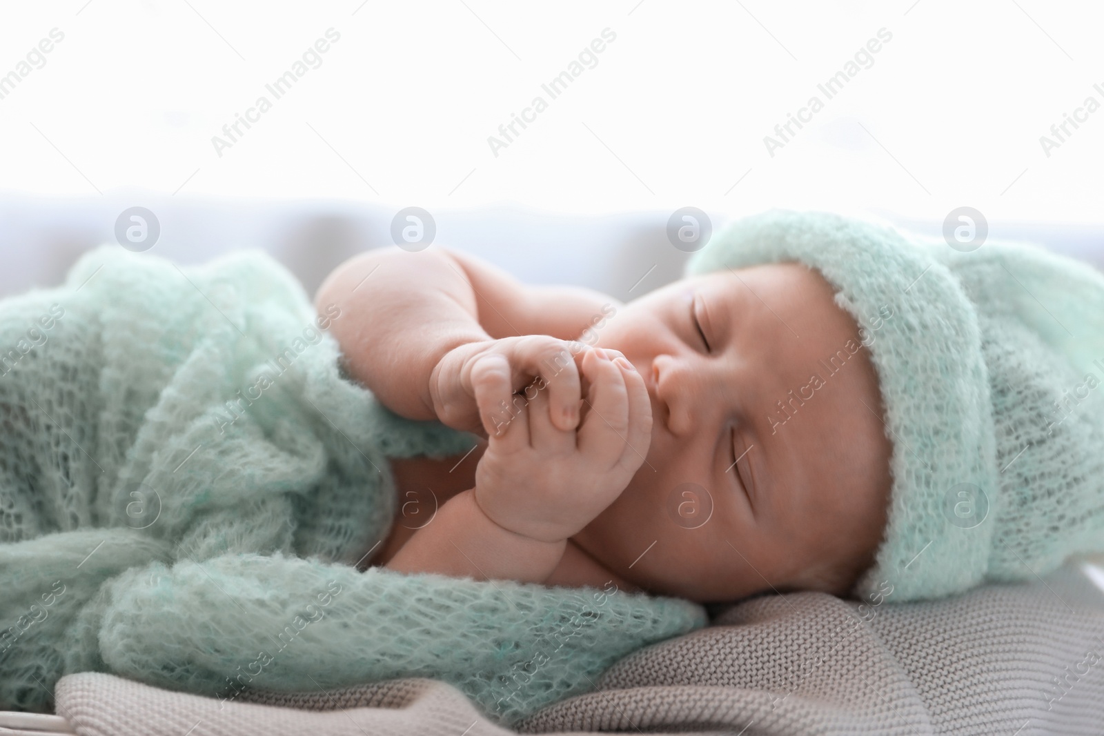 Photo of Cute newborn baby sleeping on plaid, closeup