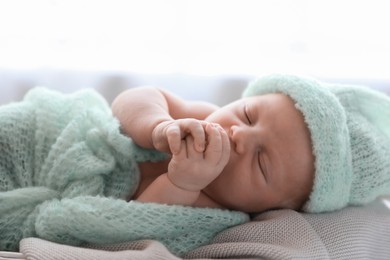 Cute newborn baby sleeping on plaid, closeup