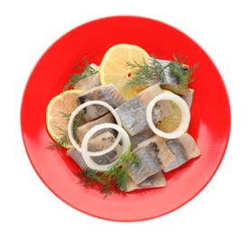 Photo of Red plate with delicious salted herring slices, lemon, onion rings and dill isolated on white, top view