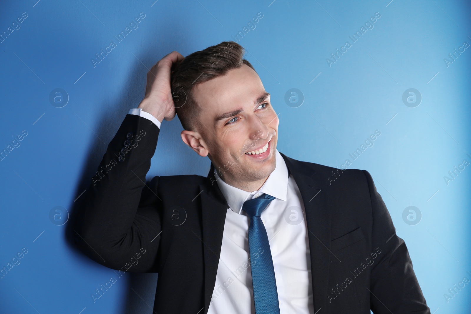 Photo of Portrait of young man with beautiful hair on color background