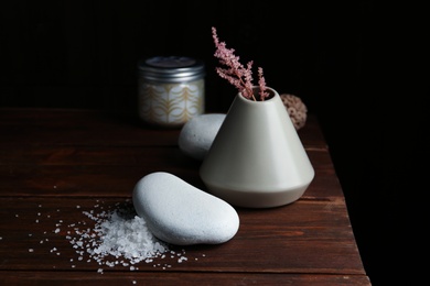 Photo of Beautiful composition with spa stone on wooden table