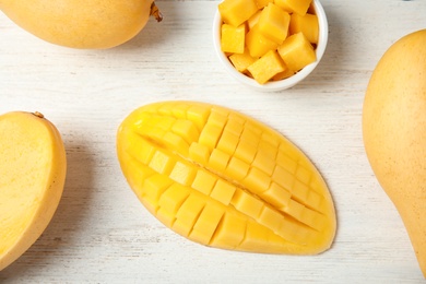 Photo of Flat lay composition with mango on wooden background