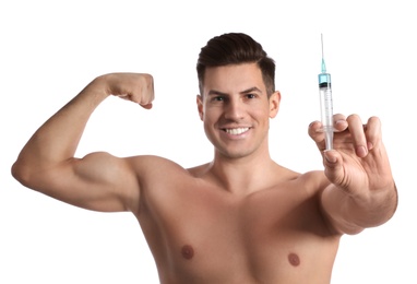 Photo of Athletic man with syringe on white background. Doping concept