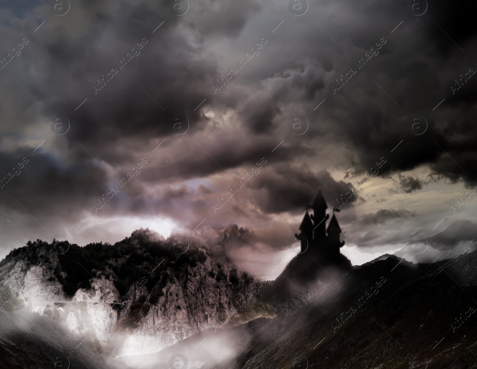 Image of Fantasy world. Mystical castle and mountains covering with fog in night