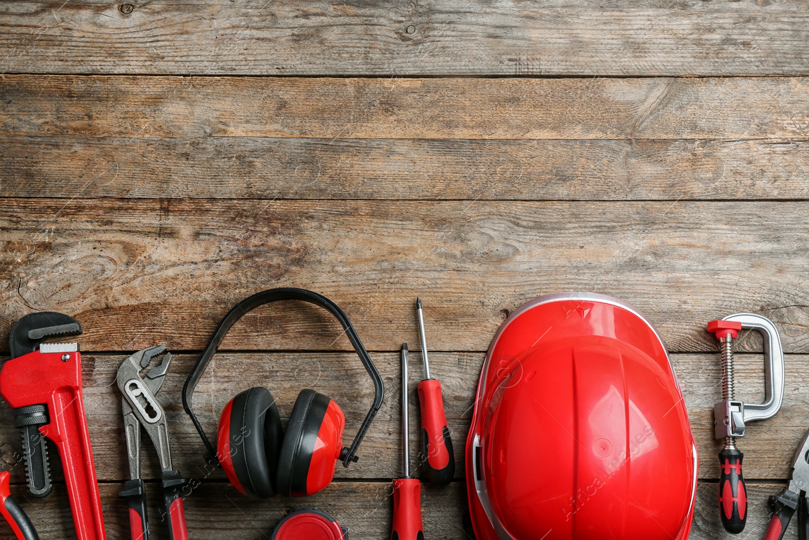 Photo of Flat lay composition with different construction tools and space for text on wooden background