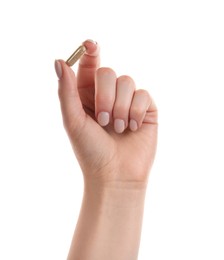 Photo of Woman holding vitamin capsule on white background, closeup. Health supplement