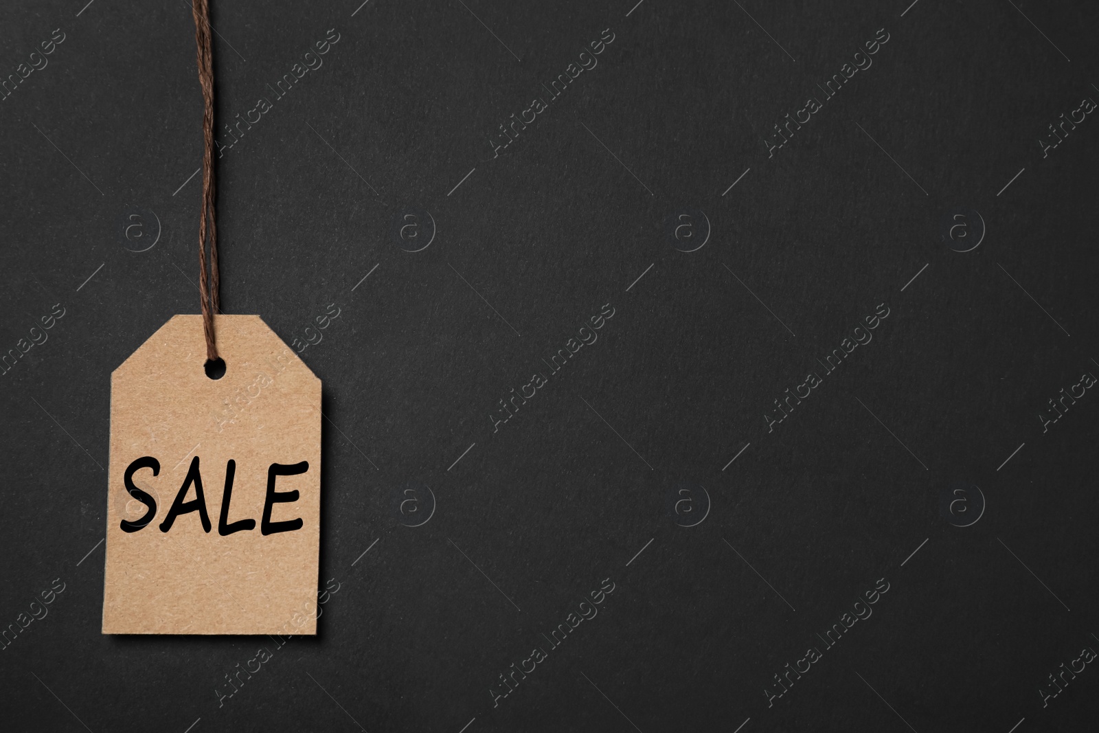 Photo of Sale tag on color background, space for text. Black Friday
